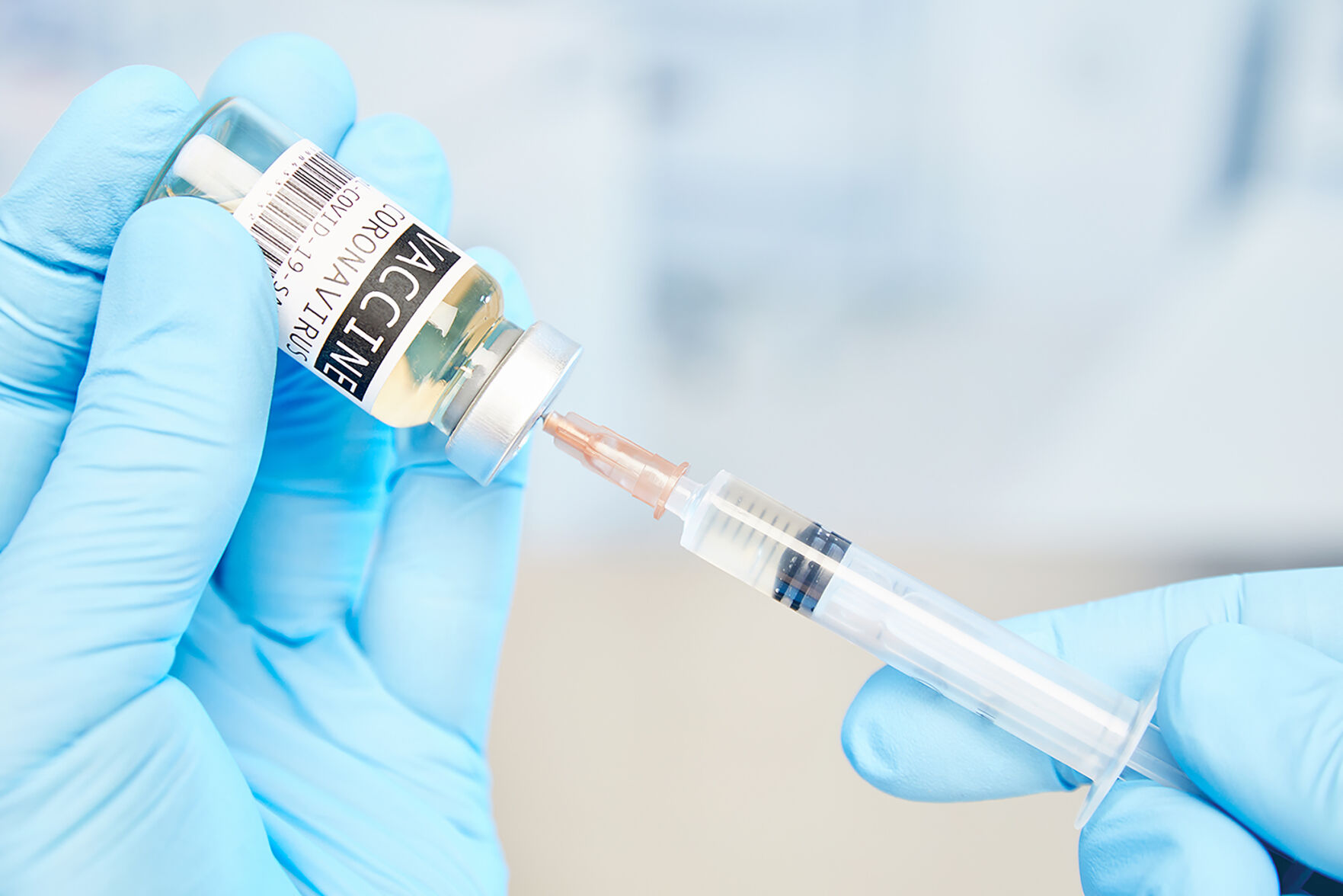 Covid-19,Vaccine,With,Syringe,And,Medical,Blue,Gloves